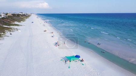 Photo for Aerial view quite beach with jus few people enjoy swimming, boating along beautiful white sandy, turquoise water, multiple shades of blue waves along Emerald Coast, Seagrove beach, Santa Rosa. USA - Royalty Free Image