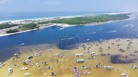 Photo for Busy Crab Island near white sandy beaches of Okaloosa Island Grass Flats in Destin, brackish water low tide and pontoons, jet skis, paddleboards, swimming, wading. Aerial Florida travel destination - Royalty Free Image