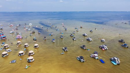 Photo for Mixed of brackish water and turquoise ocean at Crab Island with crowd of people swimming, wading, pontoons, jet skis, paddleboards at low-tide, Choctawhatchee Bay. Aerial Florida travel destination - Royalty Free Image