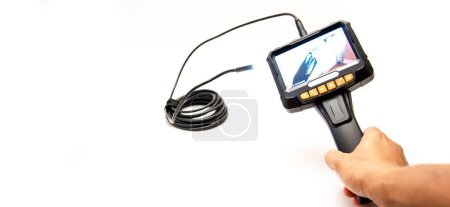Panorama view working semi-rigid cable with LED lights attached to 5 inches IPS screen of endoscope camera in Asian man hand isolated on white background. Medical industrial device visual inspection