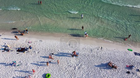 Téléchargez les photos : Diverses personnes couronnées nageant, se relaxant sur le littoral sablonneux blanc sucre, eau turquoise, South Walton plage, Destin, Floride, États-Unis, tentes colorées, verrière, chaises longues de plage. Destination de voyage - en image libre de droit