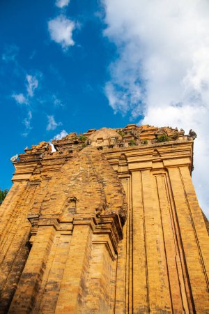 Photo for Looking up North Tower or Thap Chinh at about 28 meter high of Ponagar Cham Towers with terraced pyramidal roof, bricks under sunny blue clou sky, religious attractions in Nha Trang, Vietnam. Travel - Royalty Free Image