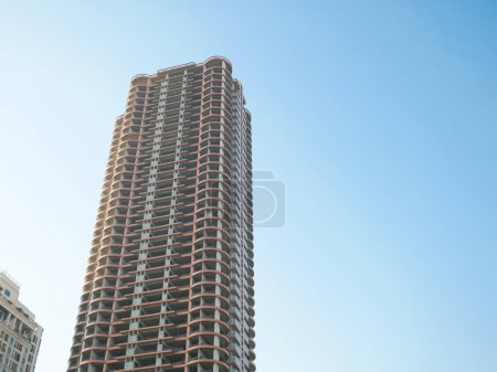 Photo for Incomplete building facadenear completed high rise apartment residential project downtown near suburbs Hanoi, Vietnam, reinforced concrete steel frame no windows, economic crisis. Recession concept - Royalty Free Image