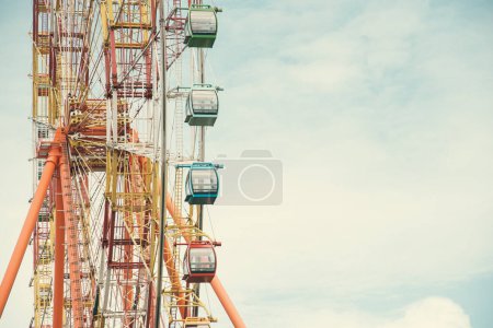 Support frame of modern colorful Ferris Wheel with axle, rim, spoke cable and sightseeing cabin, steel construction stands the weight of all components and rotation of the force and torque. Vietnam