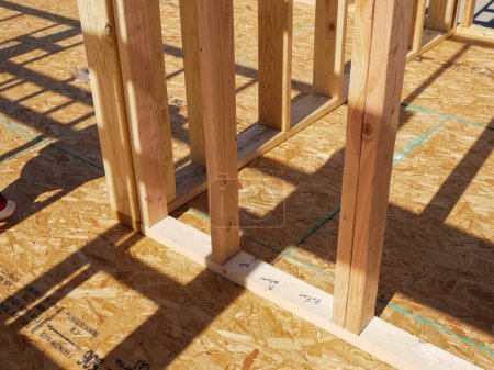 Photo for Oriented Strand Board OSB sub flooring and interior wall framing of new house construction, timber framing with posts beams studs, sheets cover joists with subfloor wood screws, Dallas, Texas. USA - Royalty Free Image