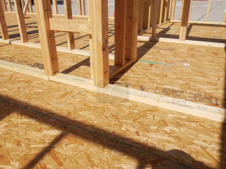 Doors and windows, interior walls framing of mobile home new construction large outdoor parking background, sub flooring sheets cover, attach to joists Oriented Strand Board plywood in Texas. USA