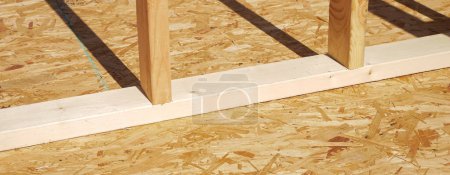 Photo for Panorama OSB sub flooring sheets cover, attach to the joists with wood screws Oriented Strand Board plywood, timber framing posts beams studs, new house construction, interior wall framing, Texas. USA - Royalty Free Image