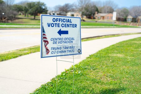 Photo for Official Vote Center yard sign with stake in English, Spanish, Vietnamese languages to welcome resident and non-English-proficient groups to voting location at elementary school in Dallas, Texas. USA - Royalty Free Image