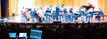 Photo for Blurry control booth and digital mixing console screen during production of symphony orchestra conductor, string, wind, bass, percussion instruments, violin, cello, trumpet, piano in Dallas, TX. USA - Royalty Free Image