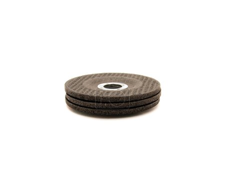 Stack of brand new aluminum oxide general purpose griding wheels, manufactured with heat treated grit grains in high concentrations cutting steel and ferrous metals, stone, isolated background. White