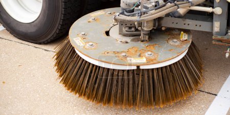 Photo for Panorama steel plate disc on gutter broom dual free-floating of modern single-engine mechanical sweeper truck, hydraulic trailing arm adjust to variable road surfaces, curbs angle sweeping, Texas. USA - Royalty Free Image