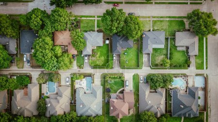 Upscale single-family homes with swimming pool and large backyard in expensive residential neighborhood suburbs Dallas, Texas, straight aerial view detached houses, wooden fence, quite street. USA