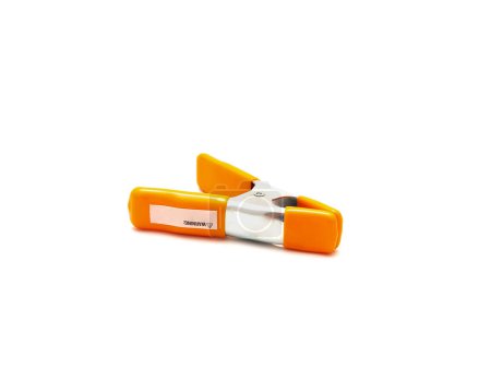 Top view spring clamp with orange poly vinyl protected handles and jaw tips contours non-slip isolated on white background, heavy duty tempered steel allows instant opening, closing. Clipping path