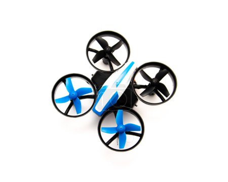 Top view indoor mini drone with protection guard for propellers isolated on white background, quadcopter auto hovering and flashing light indicator, toy for kids and beginner pilots. Education