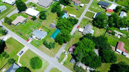 Top view suburban homes with large backyard, storage sheds in Checotah, McIntosh County, Oklahoma, medium income residential single-family houses surrounding by tall mature trees, quite streets. USA