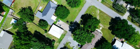 Photo for Panorama suburban homes with large backyard, storage sheds in Checotah, McIntosh County, Oklahoma, medium income residential single-family houses surrounding by tall mature trees, quite streets. USA - Royalty Free Image
