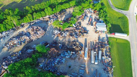 Small town recycling center near service road, pile of ferrous, nonferrous scrap metals, vehicle parts in Mountain Grove MO, vehicle part, old appliance, electronics, environmental risks, aerial. USA