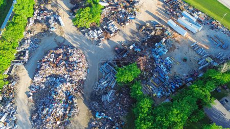 Mound of ferrous, nonferrous scrap metals, vehicle parts at large recycling center, Mountain Grove MO, vehicle part, old appliance, copper, aluminum, electronic trash, environmental risks, aerial. USA