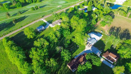 Farm houses on large acreage rural lots lush greenery trees, large storage shed in Mountain Grove Missouri, farmland and ranches in the Midwest peaceful countryside agricultural area, aerial view. USA