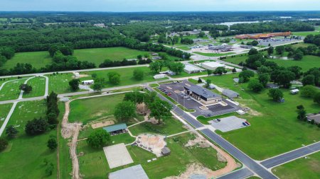 Public park under construction with splash pad, basketball court, community services building, cemetery, rural countryside landscape, lush greenery in Wyandotte, Ottawa County, Oklahoma, aerial. USA