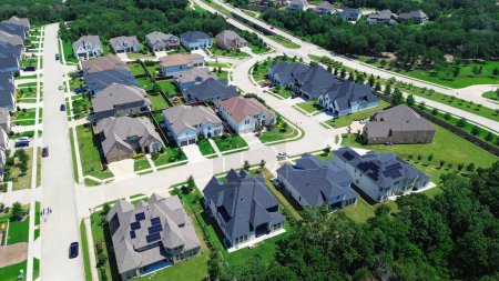Expensive new development neighborhood near highway row of upscale two-story houses solar roof panel in Dallas Fort Worth metroplex, sustainable modern Texas custom homes, Flower Mound, aerial. USA