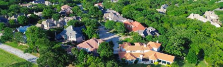 Panorama view lush green upscale residential neighborhood with expensive mansion houses wealthy suburbs area of Dallas Fort Worth metroplex, low density suburban single-family homes matured trees. USA
