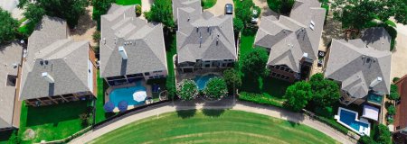 Panorama view swimming pool houses near golf course upscale residential neighborhood East of Plano, Texas, Dallas Fort Worth metroplex, grassy country club, large two-story backyard, aerial view. USA