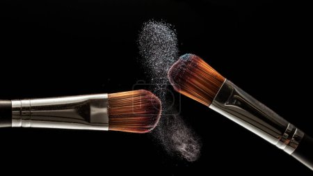 Photo for Makeup brushes and powder on a black background. Freezing - Royalty Free Image