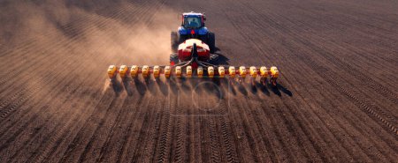 Photo for A tractor with a seeder on the field drone view, the spring season of the sowing campaign. - Royalty Free Image