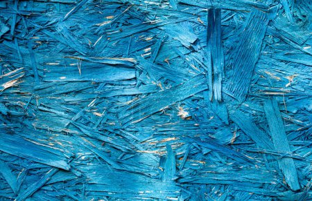 Foto de OSB plate is blue. Abstract texture of building material Made of environmentally friendly components. - Imagen libre de derechos
