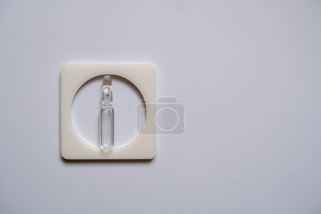 Photo for One ampoule is clear, enclosed in a square frame, with a white back. - Royalty Free Image