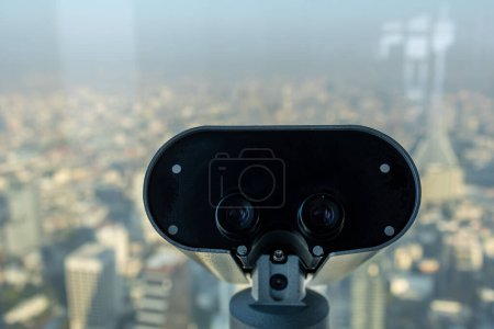 Photo for Street binoculars in front of unfocused city. on deck view. Cityscape tourism concept - with copy space - Royalty Free Image