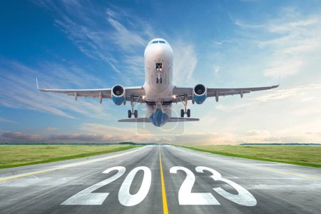 Photo for Inscription on the runway 2023 surface of the airport road yellow line take off airplane. Concept of travel in the new year, holidays - Royalty Free Image