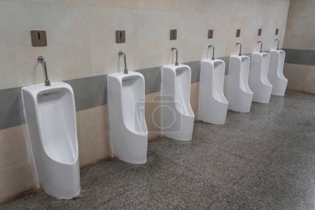 Photo for Empty row of outdoor urinals men public toilet. White ceramic urinals for man in toilet room. Gentlemen restroom in the restaurant. Interior men's toilet - Royalty Free Image