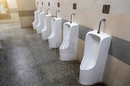 Photo for Empty row of outdoor urinals men public toilet. White ceramic urinals for man in toilet room. Gentlemen restroom in the restaurant. Interior men's toilet - Royalty Free Image