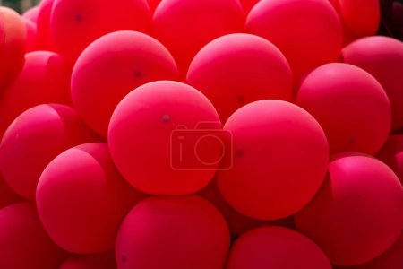 Red rubber inflatable balloons close up texture