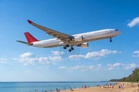 Airplane landing above beautiful beach with people on the beach and sea, travel.