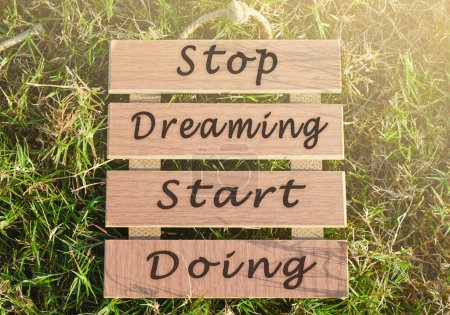 Photo for Motivational and inspirational quote on wooden frame - Stop dreaming start doing. - Royalty Free Image