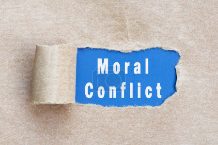 Moral conflict text on brown paper with torn hole and rolled edge.