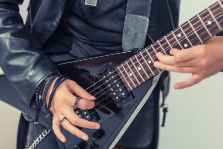 Close up of musician playing electric guitar. 