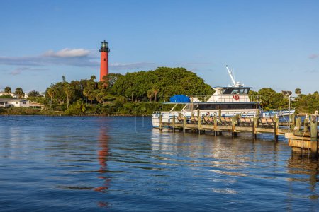 Photo for View to the Jupiter lighthouse on the north side of the Jupiter Inlet at sunset, Florida, USA - Royalty Free Image