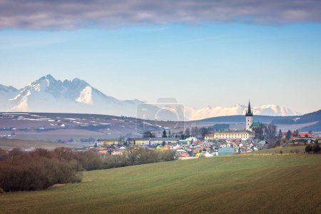 Photo for Spissky Stvrtok is a village and municipality in Levoca District in the Presov Region of central-eastern Slovakia with the High Tatras Mountains on background. - Royalty Free Image