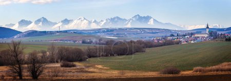 Photo for Spissky Stvrtok is a village and municipality in Levoca District in the Presov Region of central-eastern Slovakia with the High Tatras Mountains on background. - Royalty Free Image
