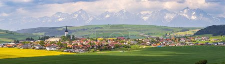 Photo for Spissky Stvrtok is a village and municipality in Levoca District in the Presov Region of central-eastern Slovakia. High Tatras on background - Royalty Free Image