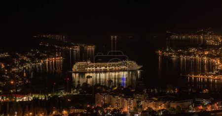 Photo for Night view to Kotor Port with illuminated cruise ship and Old Town from above. - Royalty Free Image