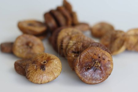 Photo for Dried Anjeer or figs from Jordan. Big and fleshy dry figs grown in jordan. They are sweet in flavour and have a leather like texture. These are soft and chewy to eat. Shot on a white background - Royalty Free Image