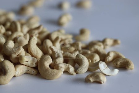 A heap of golden roasted cashews, perfect for snacks and culinary delights, capturing the essence of premium quality and irresistible flavor. Shot on white background
