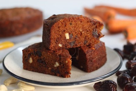 Carrot and date cake. Delicious, healthy and moist dessert. Perfect for vegan, gluten free, paleo diets. For celebrations and guilt free indulgence. Shot with carrots and dates on white background