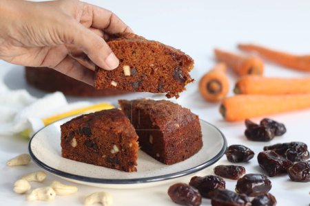 Carrot and date cake. Delicious, healthy and moist dessert. Perfect for vegan, gluten free, paleo diets. For celebrations and guilt free indulgence. Shot with carrots and dates on white background