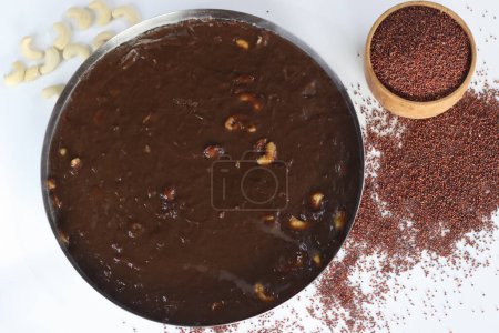 Delectable Ragi Halwa in round steel plate mold, Indian dessert, nutritious, vegan, gluten-free, sweet, perfect for foodies and health-conscious. Halwa made with finger millet flour and cashews